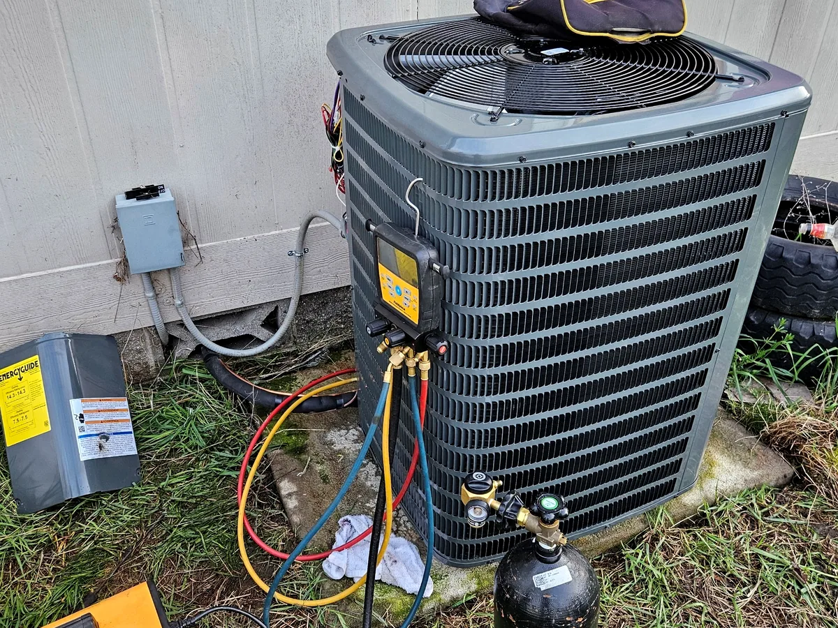 Technician servicing an outdoor HVAC unit