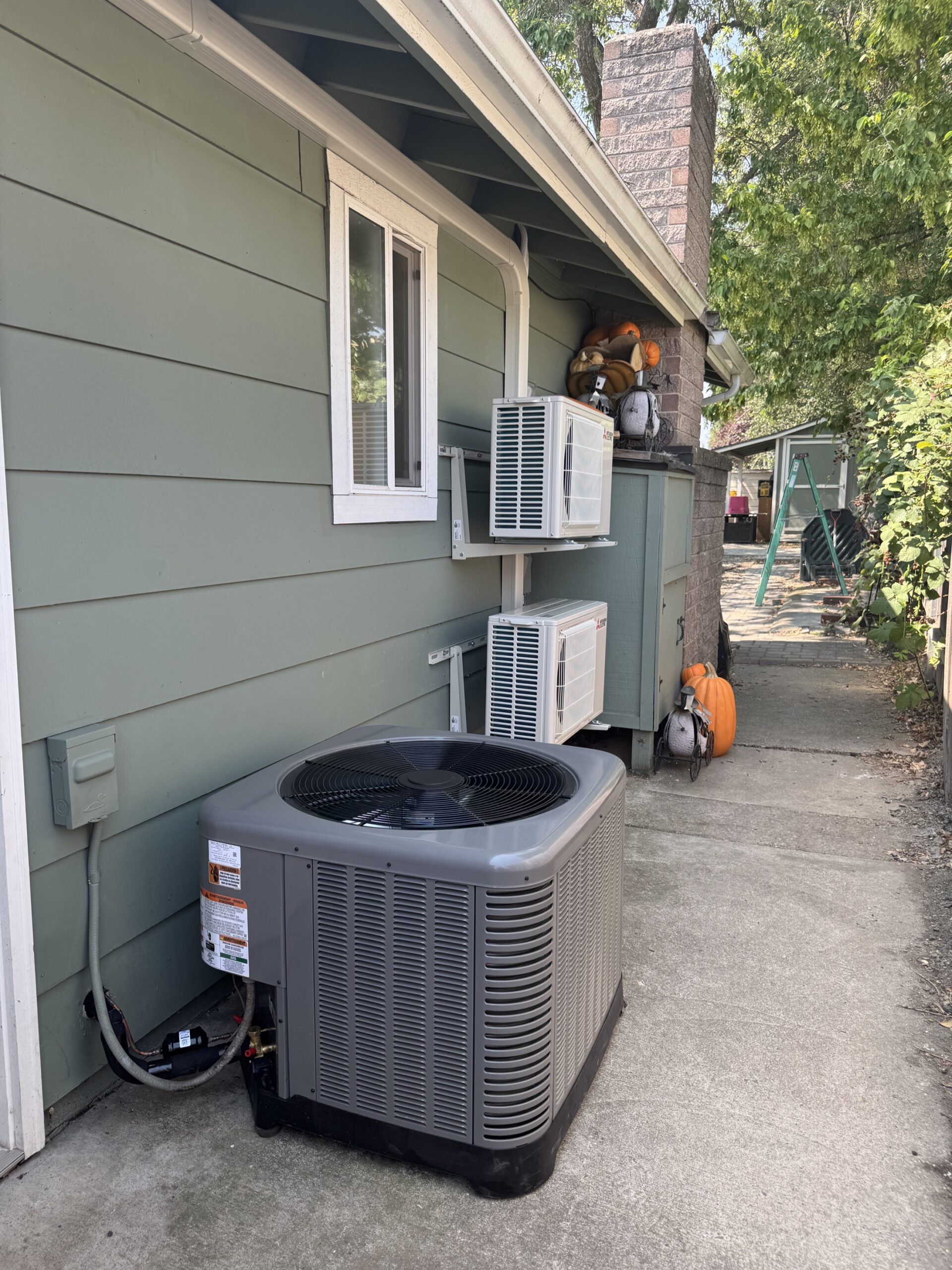 RUUD outdoor HVAC unit installed beside a home